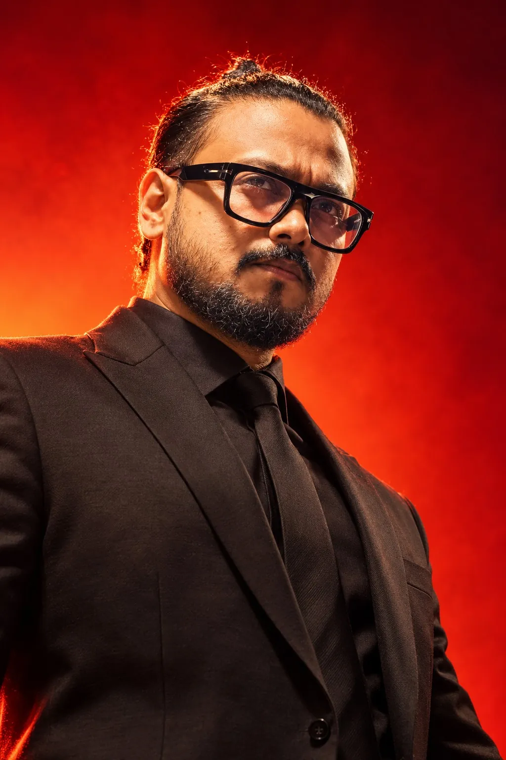 Shubho Gupta portrait against an intense red and orange background